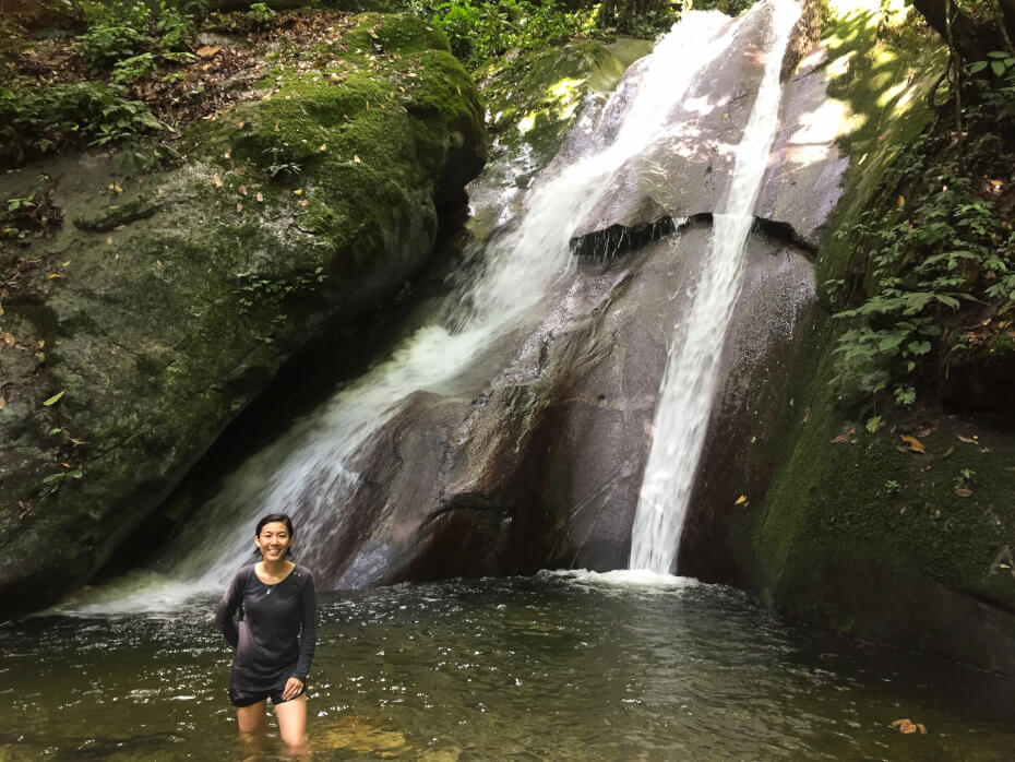 Teoh (right) and her two friends enjoying the fresh water nearby Kipungit Waterfall.